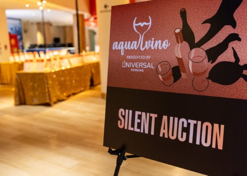 silent auction sign with tables in the background